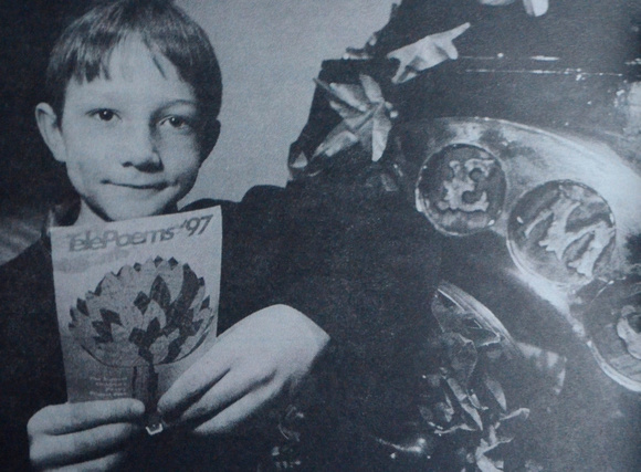8-year-old Adam Devereaux checks out his published poem, Day Dreams 1997 Bray People