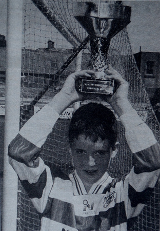 Greysrtones U13s' Emmet Killeen holds the Premier Division Cup 1997 Bray People
