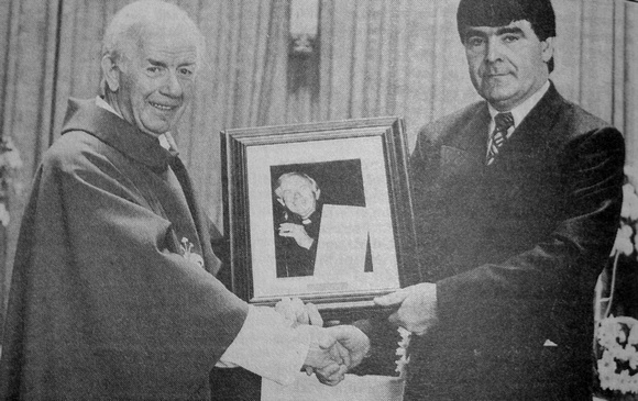 Fr Eamonn Cotter receives a farewell gift he can't refuse from Tom 'The Don' Fortune 1997 Bray People