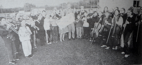 Greystones Youth Orchestra present Jackie Clarkin a £3,000 cheque for the new community centre 1998 Bray People