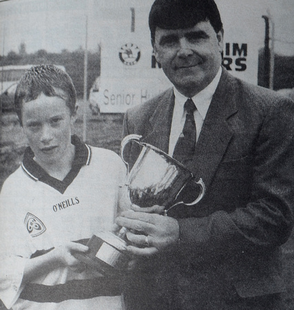 Tom Fortune takes the Under 12 cup away from St Joseph's captain Andew Loughlin. The swine. 1998 Bray People