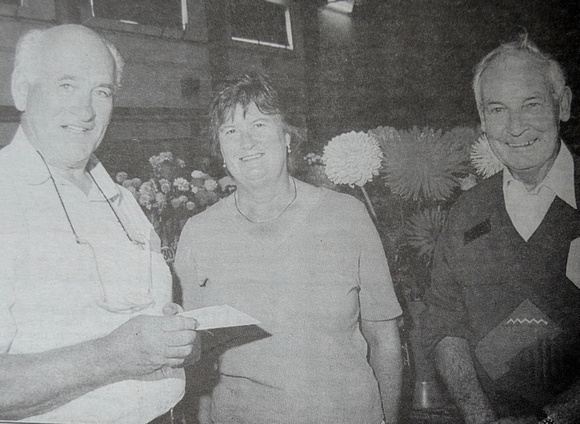 Judge Pat Hackett gives Margaret & Dick Kelly their Best Novice Dahlia Grower award 1999 Bray People