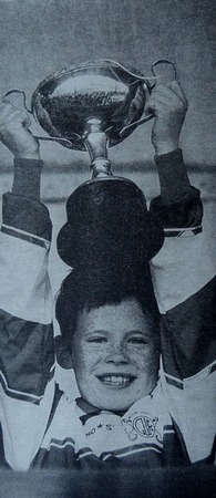 Greystones U8 captain Kevin Glynn lifts the cup 1999 Bray People